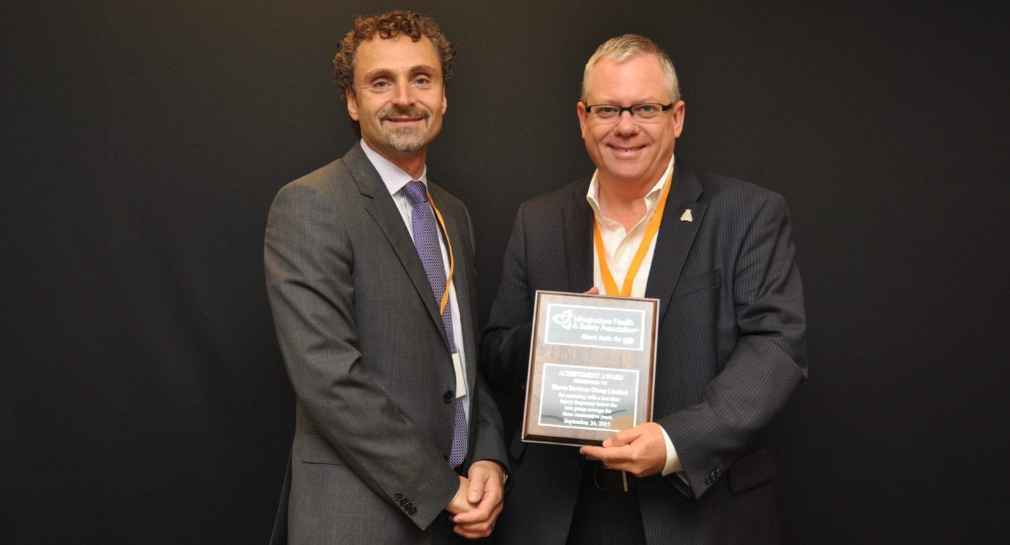 John Harrison is pictured receiving the award from Enzo Garritano, IHSA Acting president & CEO